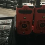 Motorola Handheld Walkie Talkies, Orange/black, Carrying Case, Accessories. Fixed Price $100.00.